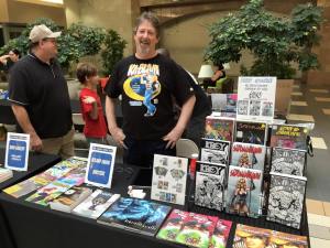 Me manning the table during FCBD 2015 at Coliseum of Comics Fashion Square Mall. You can see my pal Barry off to my right.